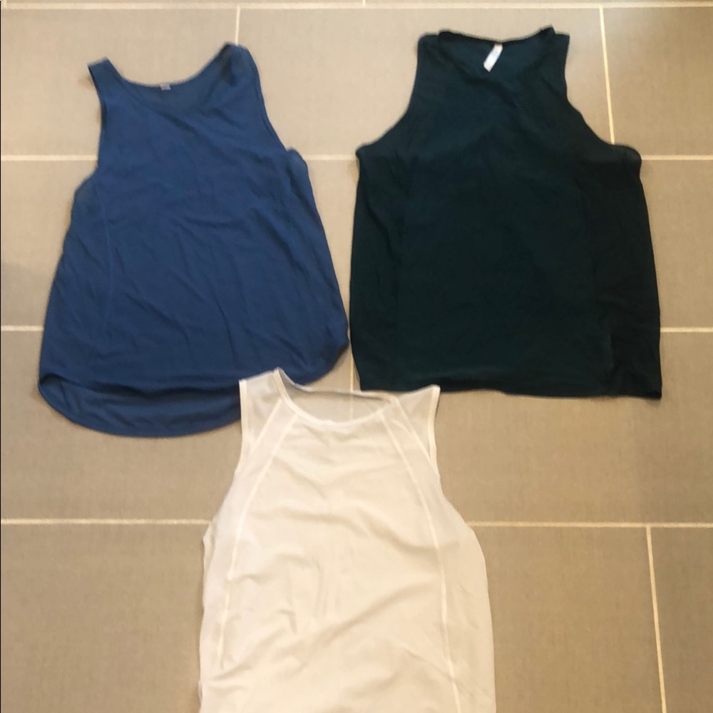 Lululemon Blue tank and white tank top. ONE Athleta green tank top. All size M